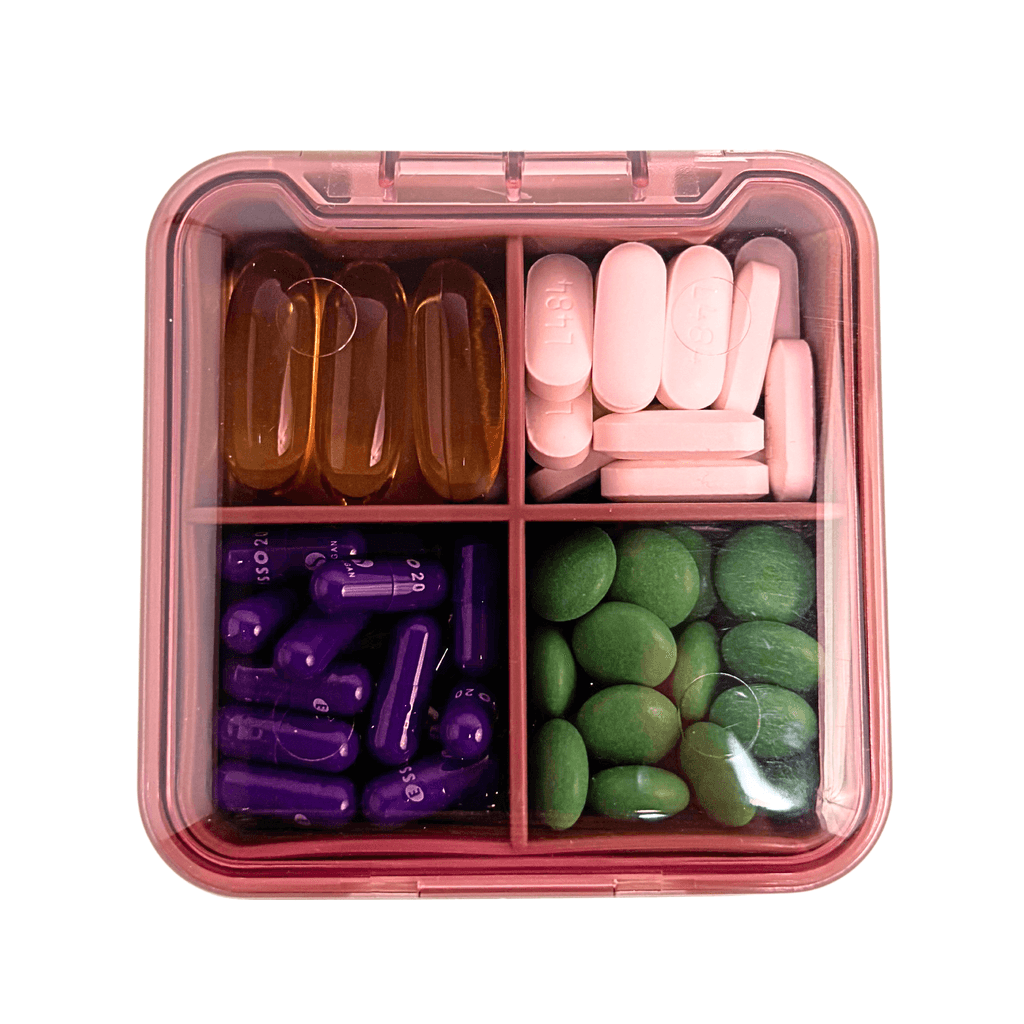 Pink compartment visibility in portable pill organizer with matching silicone travel pouch for easy identification
